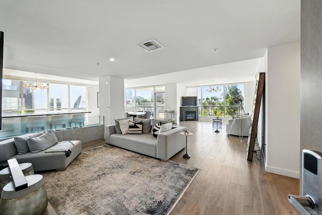 510 First Ave Unit 402, San Diego, CA 92101 - living room featuring a chandelier, hardwood / wood-style floors, baseboards, and recessed lighting