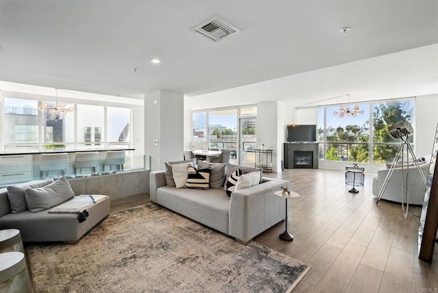 510 First Ave Unit 402, San Diego, CA 92101 - living room featuring a chandelier, wood finished floors, a glass covered fireplace, and recessed lighting