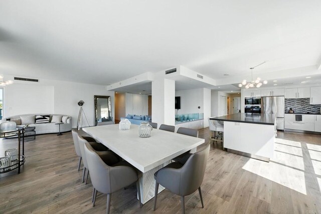 510 First Ave Unit 402, San Diego, CA 92101 - dining room featuring a chandelier and light wood finished floors