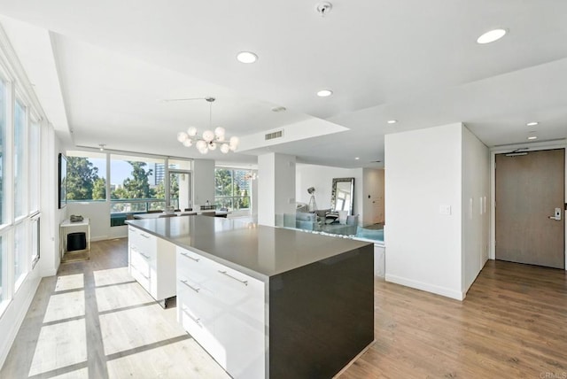 510 First Ave Unit 402, San Diego, CA 92101 - kitchen with a center island, light wood-style floors, recessed lighting, and white cabinets