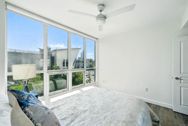 510 First Ave Unit 402, San Diego, CA 92101 - bedroom featuring wood finished floors, baseboards, a wall of windows, and ceiling fan