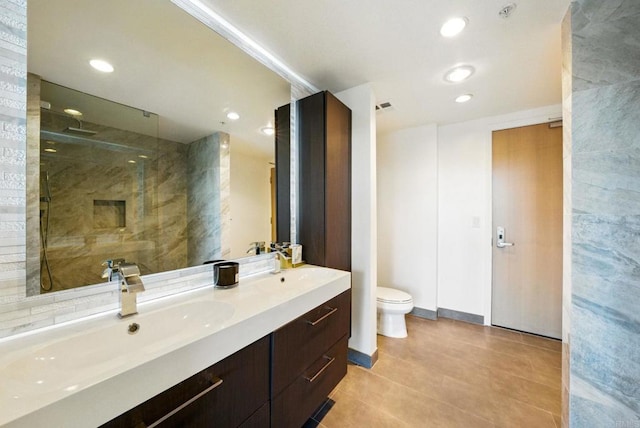 510 First Ave Unit 402, San Diego, CA 92101 - bathroom with toilet, double vanity, walk in shower, tile patterned flooring, and recessed lighting