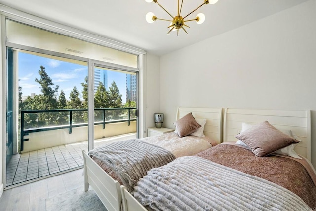 510 First Ave Unit 402, San Diego, CA 92101 - bedroom featuring a chandelier, wood finished floors, and access to outside