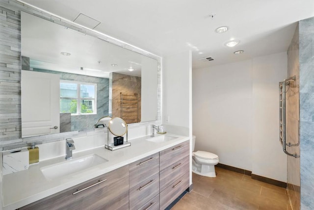 510 First Ave Unit 402, San Diego, CA 92101 - bathroom with double vanity, toilet, a shower, and baseboards