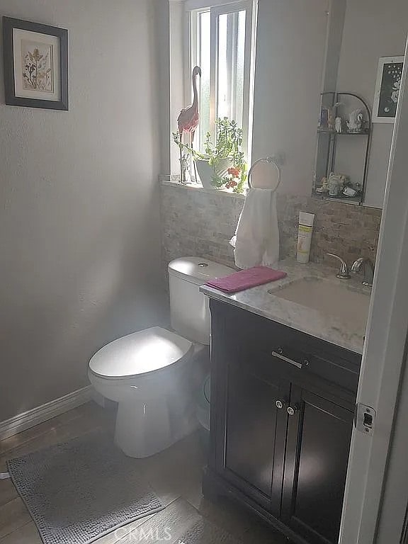 13914 Prichard St, La Puente, CA 91746 - bathroom featuring vanity, toilet, tile patterned flooring, and baseboards