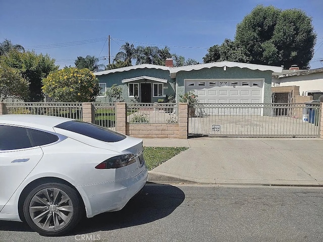 13914 Prichard St, La Puente, CA 91746 - view of front of property featuring a garage, a fenced front yard, driveway, stucco siding, and a gate