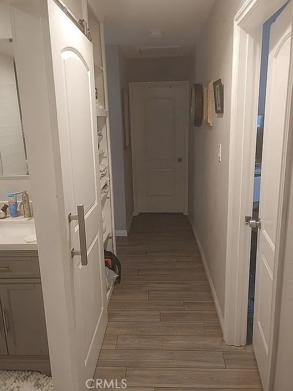 13914 Prichard St, La Puente, CA 91746 - corridor featuring light wood-style flooring and baseboards