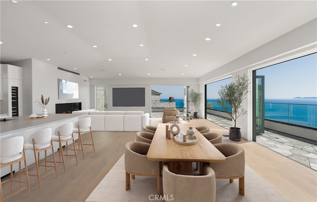31 N Vista De Catalina, Laguna Beach, CA 92651 - dining room featuring light wood-style floors, recessed lighting, a warm lit fireplace, and plenty of natural light