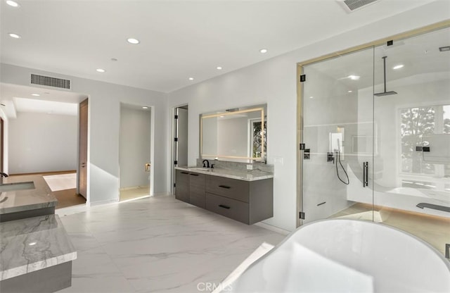 31 N Vista De Catalina, Laguna Beach, CA 92651 - bathroom with two vanities, a freestanding tub, a shower stall, recessed lighting, and marble finish flooring