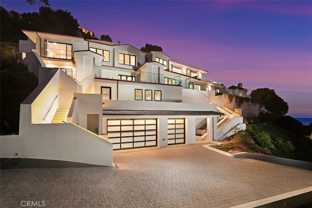 31 N Vista De Catalina, Laguna Beach, CA 92651 - view of front facade with stairway, stucco siding, driveway, a garage, and a balcony