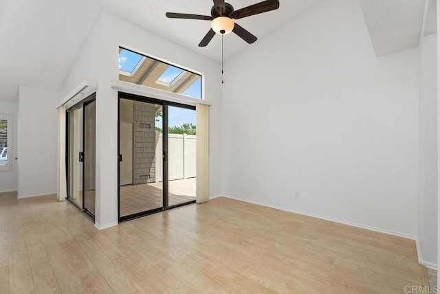 8933 Yolo Cir Unit 1308-A, Huntington Beach, CA 92646 - unfurnished room with plenty of natural light, light wood-style floors, ceiling fan, baseboards, and a high ceiling