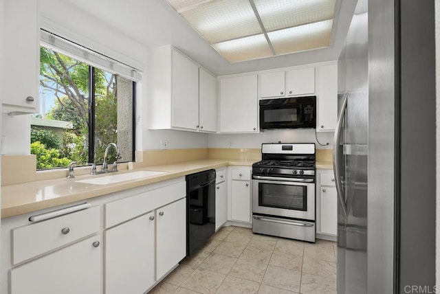 8933 Yolo Cir Unit 1308-A, Huntington Beach, CA 92646 - kitchen featuring black appliances, a sink, white cabinets, light countertops, and light tile patterned floors