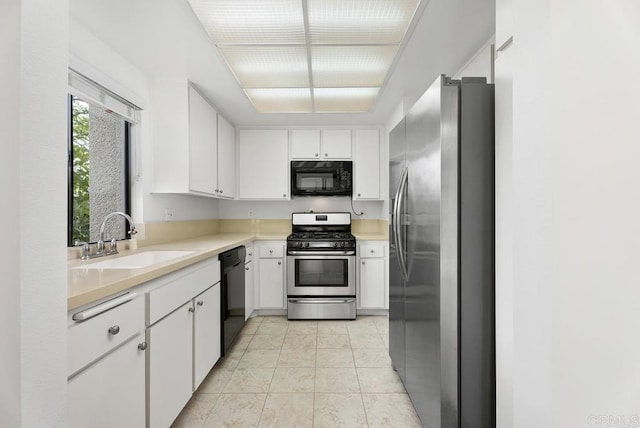 8933 Yolo Cir Unit 1308-A, Huntington Beach, CA 92646 - kitchen featuring black appliances, a sink, light countertops, and white cabinets