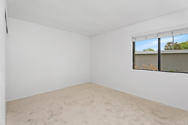 8933 Yolo Cir Unit 1308-A, Huntington Beach, CA 92646 - carpeted spare room featuring baseboards and a textured ceiling