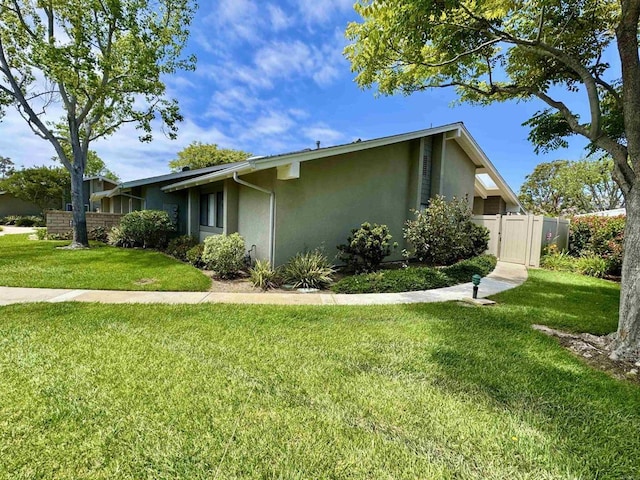 8933 Yolo Cir Unit 1308-A, Huntington Beach, CA 92646 - view of side of property featuring stucco siding and a gate