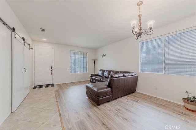 13868 Rosemary St, Hesperia, CA 92344 - living room with a barn door, a chandelier, baseboards, light wood-type flooring, and recessed lighting