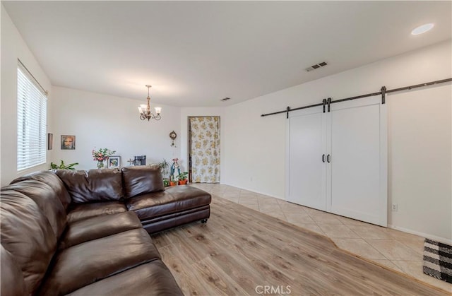 13868 Rosemary St, Hesperia, CA 92344 - living room with a barn door, a chandelier, and light tile patterned floors