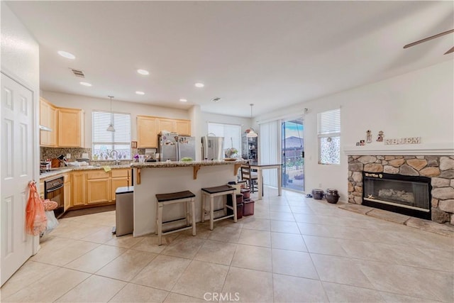 13868 Rosemary St, Hesperia, CA 92344 - kitchen featuring light brown cabinets, freestanding refrigerator, oven, plenty of natural light, and recessed lighting