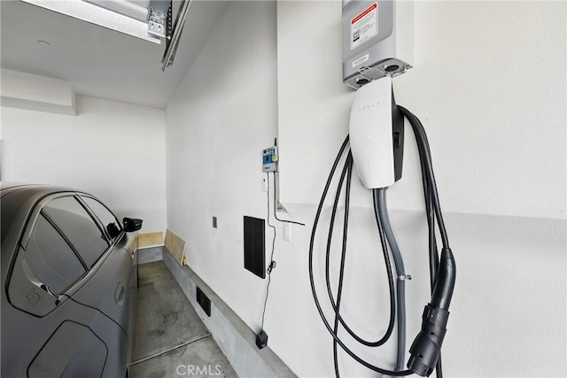 1782 Park Place Ln, Riverside, CA 92501 - garage view of concrete floors, washer / clothes dryer, electric vehicle charger, and baseboards
