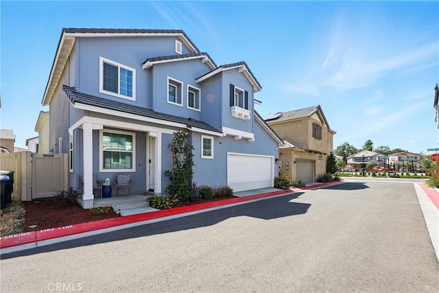 1782 Park Place Ln, Riverside, CA 92501 - view of front facade with an attached garage, a gate, driveway, and a residential view