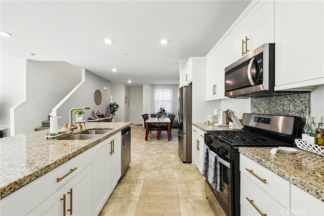 1782 Park Place Ln, Riverside, CA 92501 - kitchen featuring appliances with stainless steel finishes, a sink, white cabinets, recessed lighting, and light stone countertops