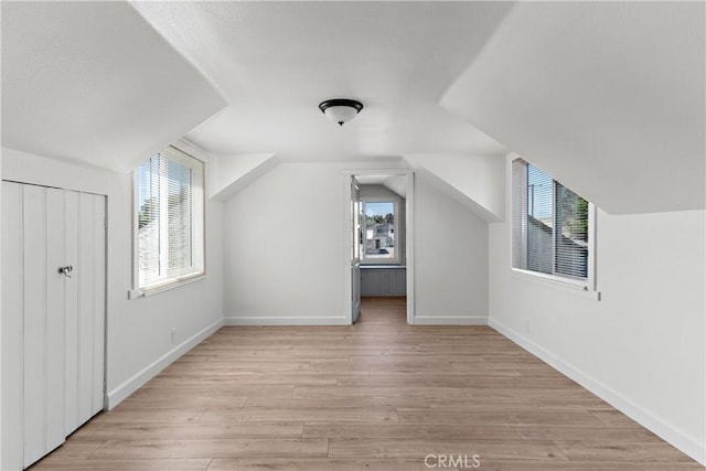 407 W 107th St, Los Angeles, CA 90003 - additional living space featuring plenty of natural light, light wood-type flooring, lofted ceiling, and baseboards