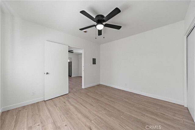407 W 107th St, Los Angeles, CA 90003 - spare room featuring light wood finished floors, a ceiling fan, and baseboards