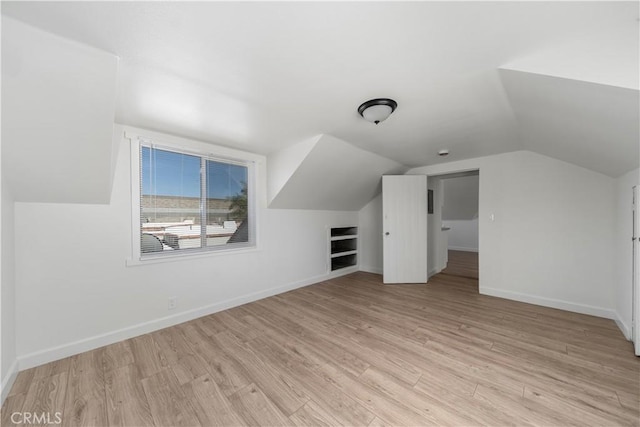 407 W 107th St, Los Angeles, CA 90003 - bonus room featuring vaulted ceiling, baseboards, and light wood-style floors