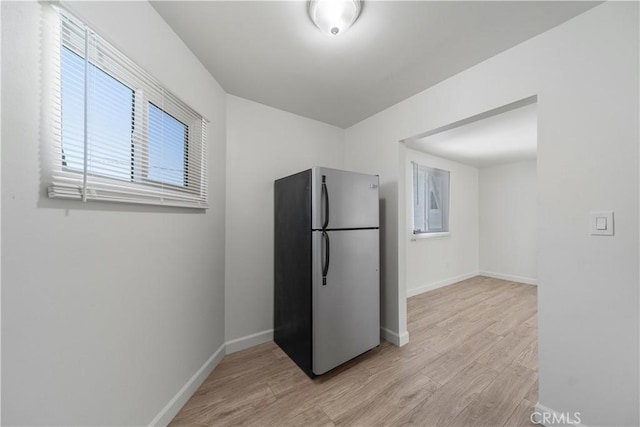 407 W 107th St, Los Angeles, CA 90003 - kitchen with freestanding refrigerator, light wood-style floors, and baseboards