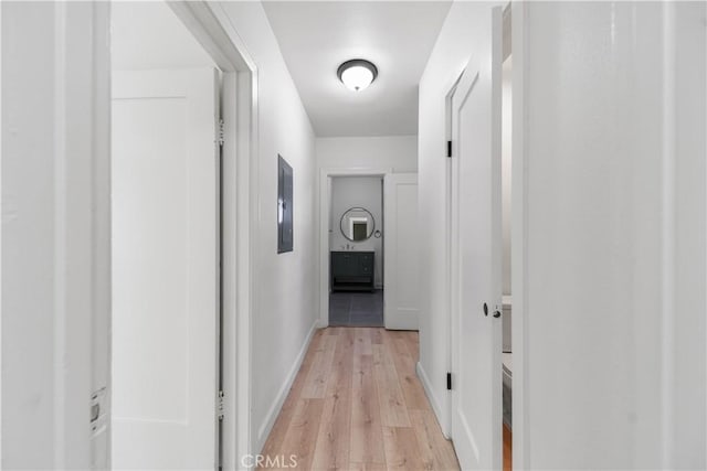 407 W 107th St, Los Angeles, CA 90003 - hall with electric panel, light wood-style flooring, and baseboards