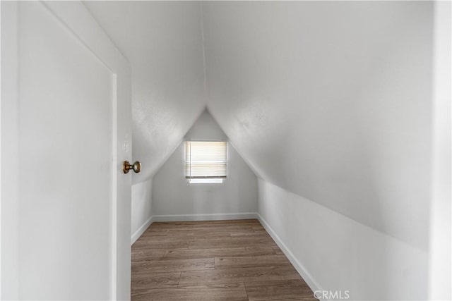 407 W 107th St, Los Angeles, CA 90003 - additional living space with wood finished floors, lofted ceiling, and baseboards