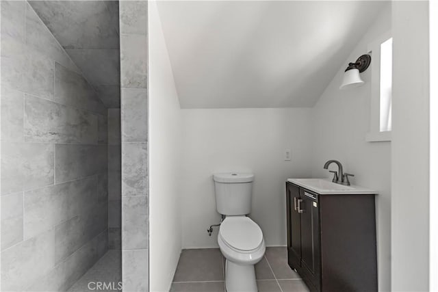 407 W 107th St, Los Angeles, CA 90003 - bathroom featuring lofted ceiling, vanity, toilet, tiled shower, and tile patterned floors