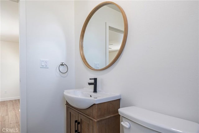 407 W 107th St, Los Angeles, CA 90003 - bathroom with toilet, wood finished floors, and vanity