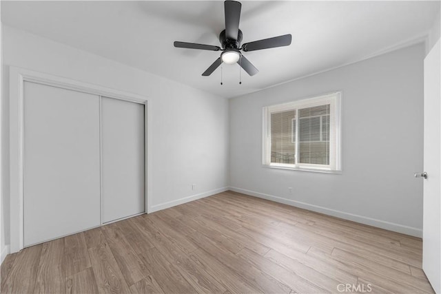 407 W 107th St, Los Angeles, CA 90003 - unfurnished bedroom with wood finished floors, a closet, baseboards, and a ceiling fan