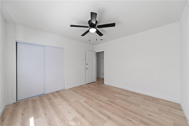 407 W 107th St, Los Angeles, CA 90003 - unfurnished bedroom with light wood finished floors, baseboards, a closet, and a ceiling fan