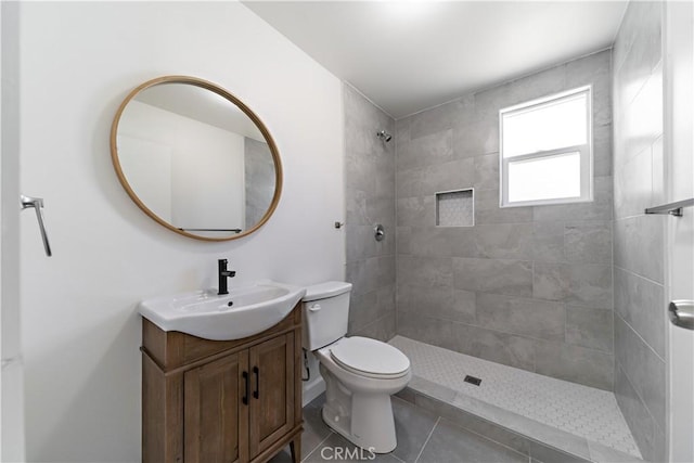 407 W 107th St, Los Angeles, CA 90003 - bathroom featuring vanity, toilet, a tile shower, and tile patterned flooring