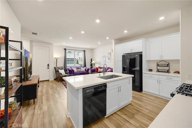 1095 W Buttercup Ln, Rialto, CA 92376 - kitchen featuring black appliances, a sink, open floor plan, light wood finished floors, and recessed lighting