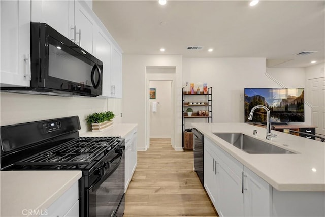 1095 W Buttercup Ln, Rialto, CA 92376 - kitchen featuring black appliances, a sink, light wood finished floors, light countertops, and white cabinetry