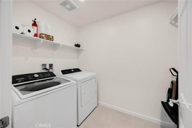 1095 W Buttercup Ln, Rialto, CA 92376 - washroom featuring washer and clothes dryer, baseboards, and light tile patterned flooring