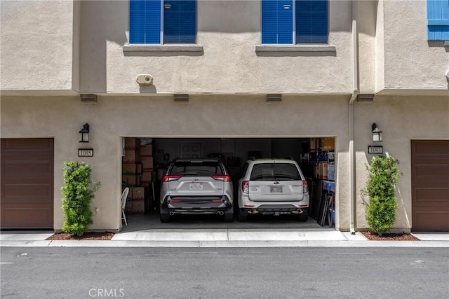 1095 W Buttercup Ln, Rialto, CA 92376 - back of house with an attached garage and stucco siding