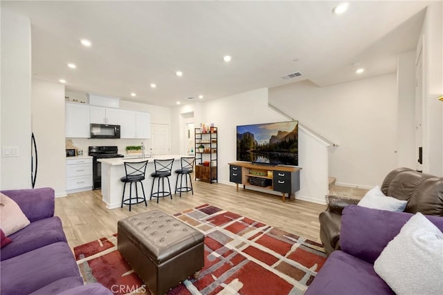 1095 W Buttercup Ln, Rialto, CA 92376 - living area featuring light wood-type flooring, recessed lighting, baseboards, and stairs