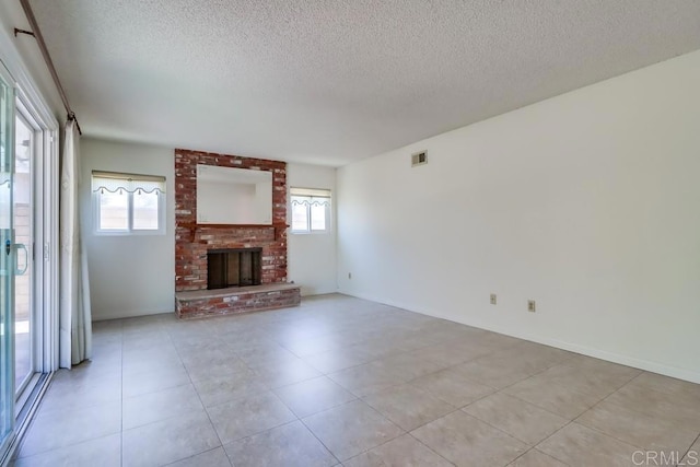 817 Cedar Ave, Chula Vista, CA 91911 - unfurnished living room featuring a textured ceiling, a fireplace, and light tile patterned floors