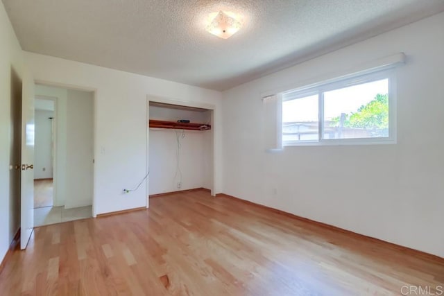 817 Cedar Ave, Chula Vista, CA 91911 - unfurnished bedroom with light wood-style floors, a closet, a textured ceiling, and baseboards