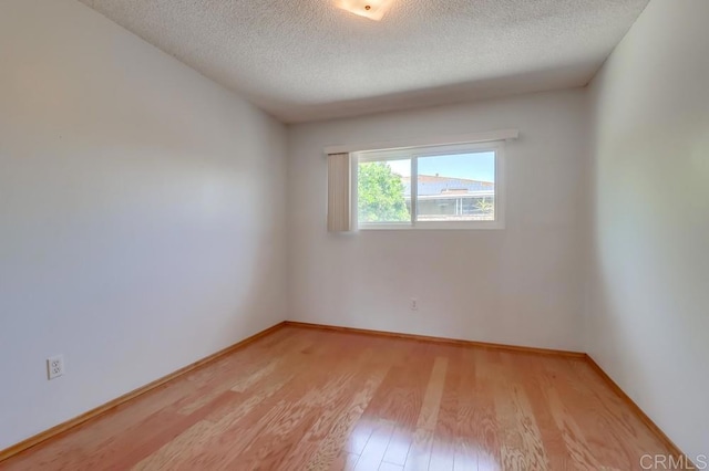 817 Cedar Ave, Chula Vista, CA 91911 - unfurnished room featuring light wood-type flooring, a textured ceiling, and baseboards