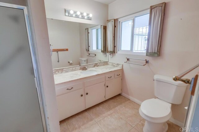 817 Cedar Ave, Chula Vista, CA 91911 - full bath featuring toilet, vanity, baseboards, tile patterned floors, and a shower with shower door