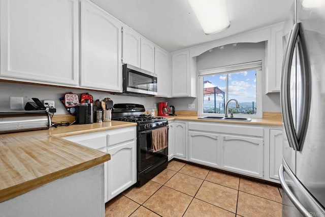 865 Worthington St, San Diego, CA 92114 - kitchen with stainless steel appliances, a sink, light tile patterned floors, and white cabinets