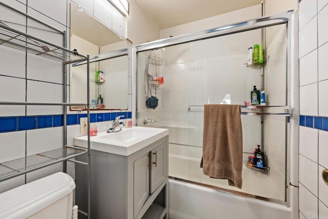 865 Worthington St, San Diego, CA 92114 - full bathroom featuring toilet, enclosed tub / shower combo, vanity, and tile walls