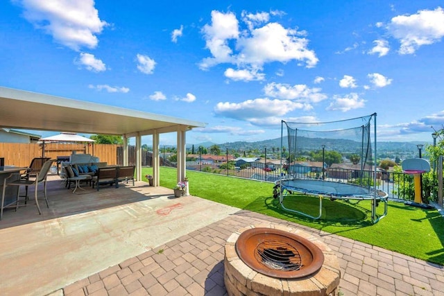 865 Worthington St, San Diego, CA 92114 - view of patio / terrace with a trampoline, an outdoor fire pit, outdoor dining space, and a mountain view