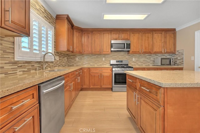 12415 Brianwood Dr, Riverside, CA 92503 - kitchen with appliances with stainless steel finishes, a sink, ornamental molding, and brown cabinets
