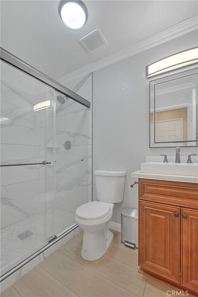 12415 Brianwood Dr, Riverside, CA 92503 - full bathroom featuring toilet, crown molding, vanity, a marble finish shower, and a textured ceiling
